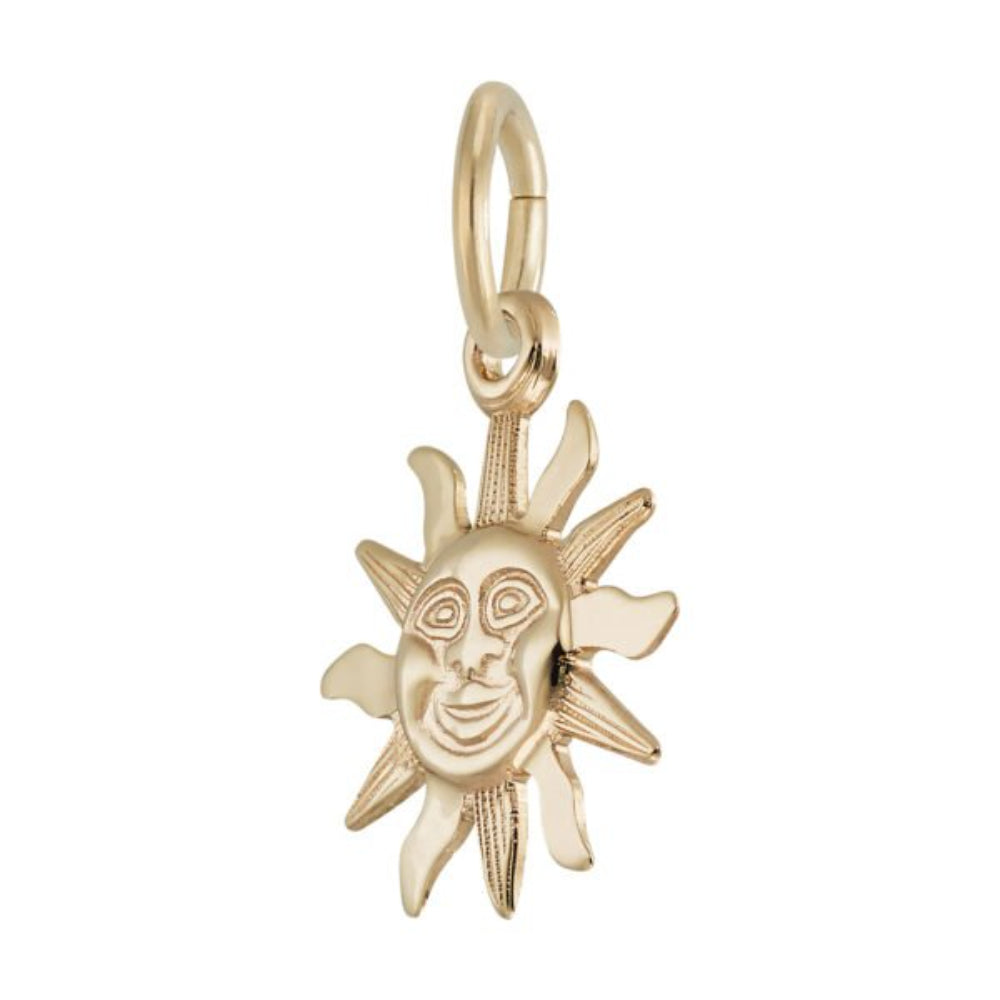 Gold sun-shaped pendant with face design on a white background