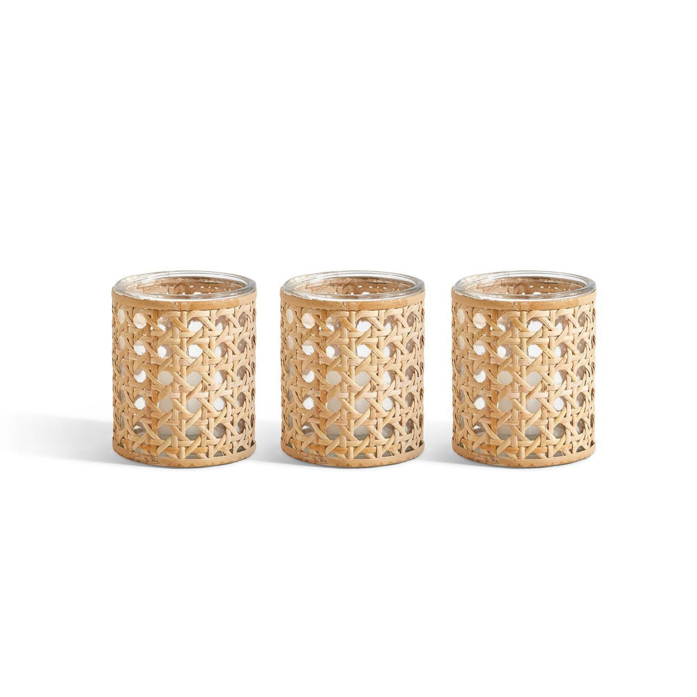 Three woven rattan candle holders on a white background.