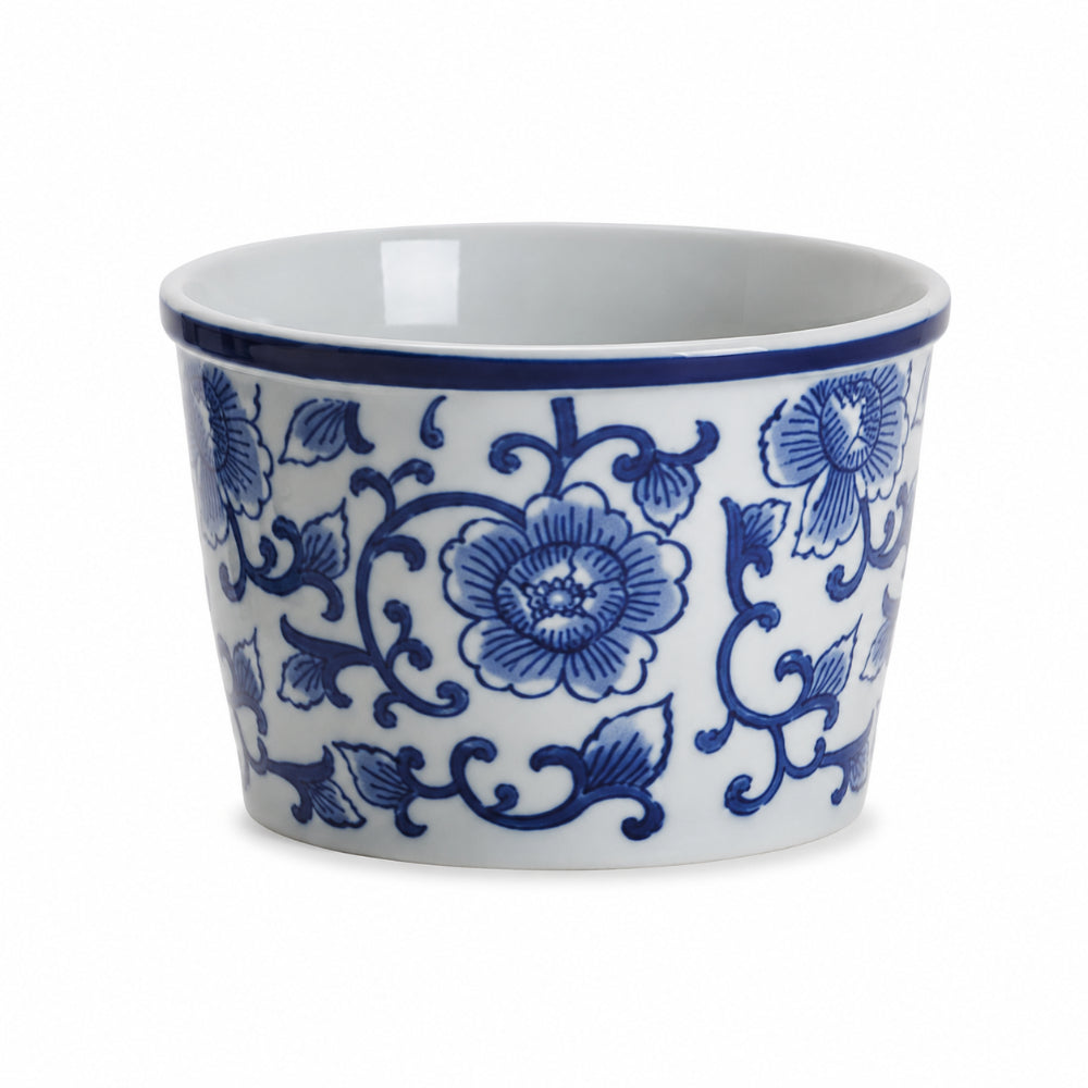 A white ceramic bowl decorated with a classic blue floral and vine pattern, featuring a matching blue rim, shown against a plain white background.