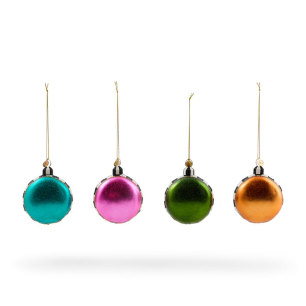 Four small metallic Christmas ornaments in teal, pink, green, and orange, each with a gold hanging string, shown against a plain white background.
