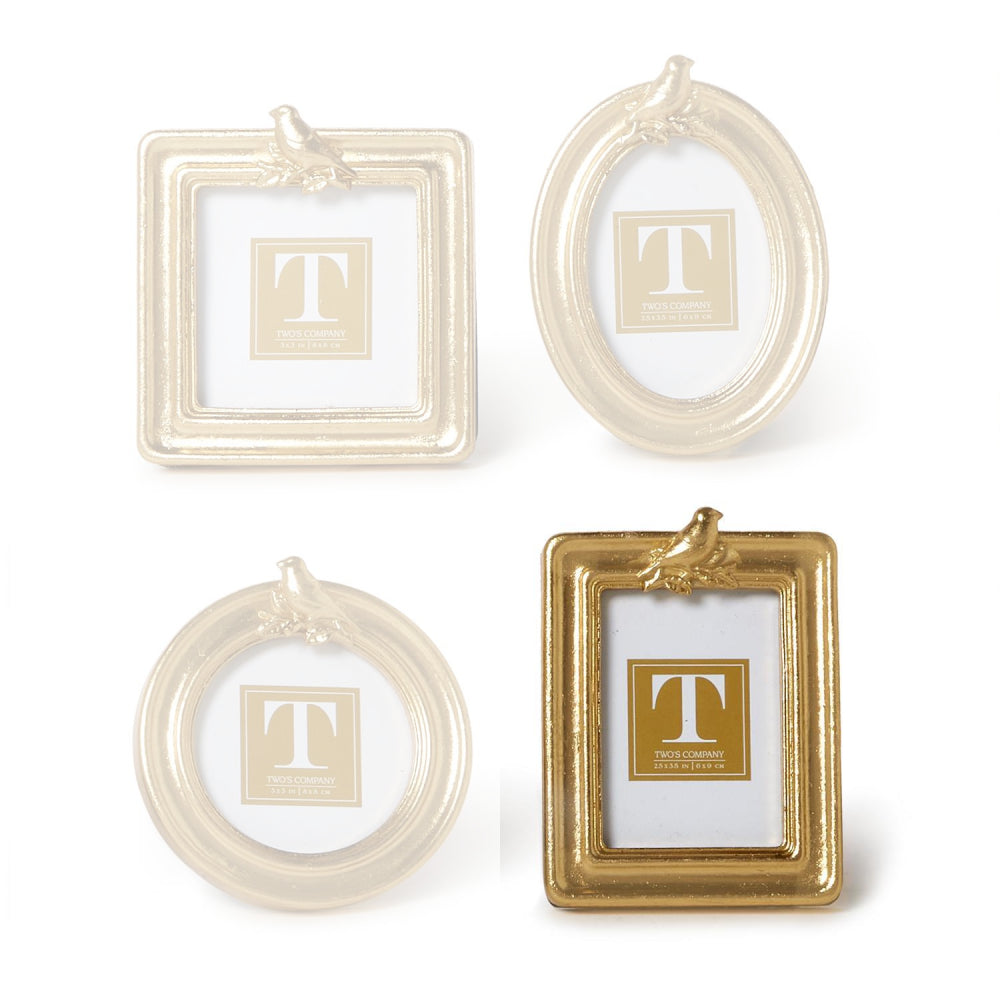 Rectangle gold picture frame with a gold bird on the top a white background.