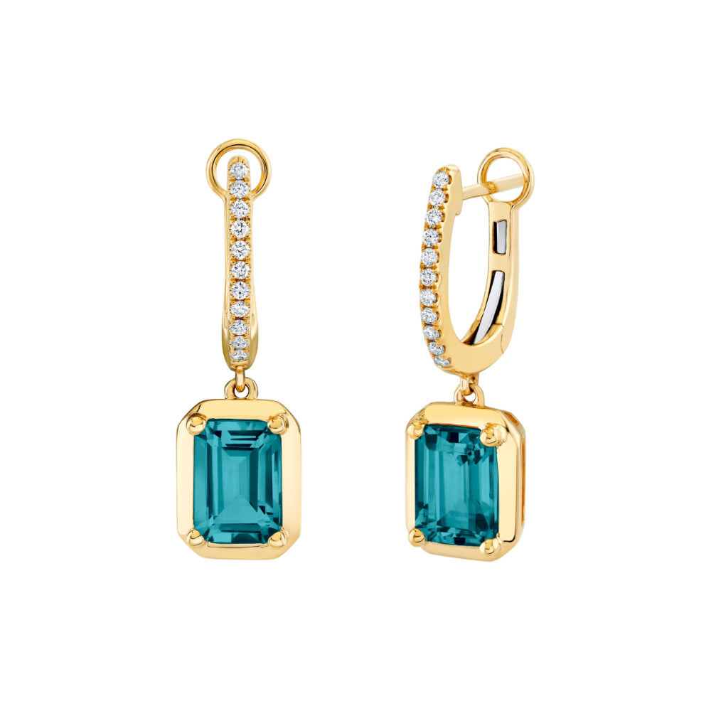 Gold earrings with blue gemstones on a white background