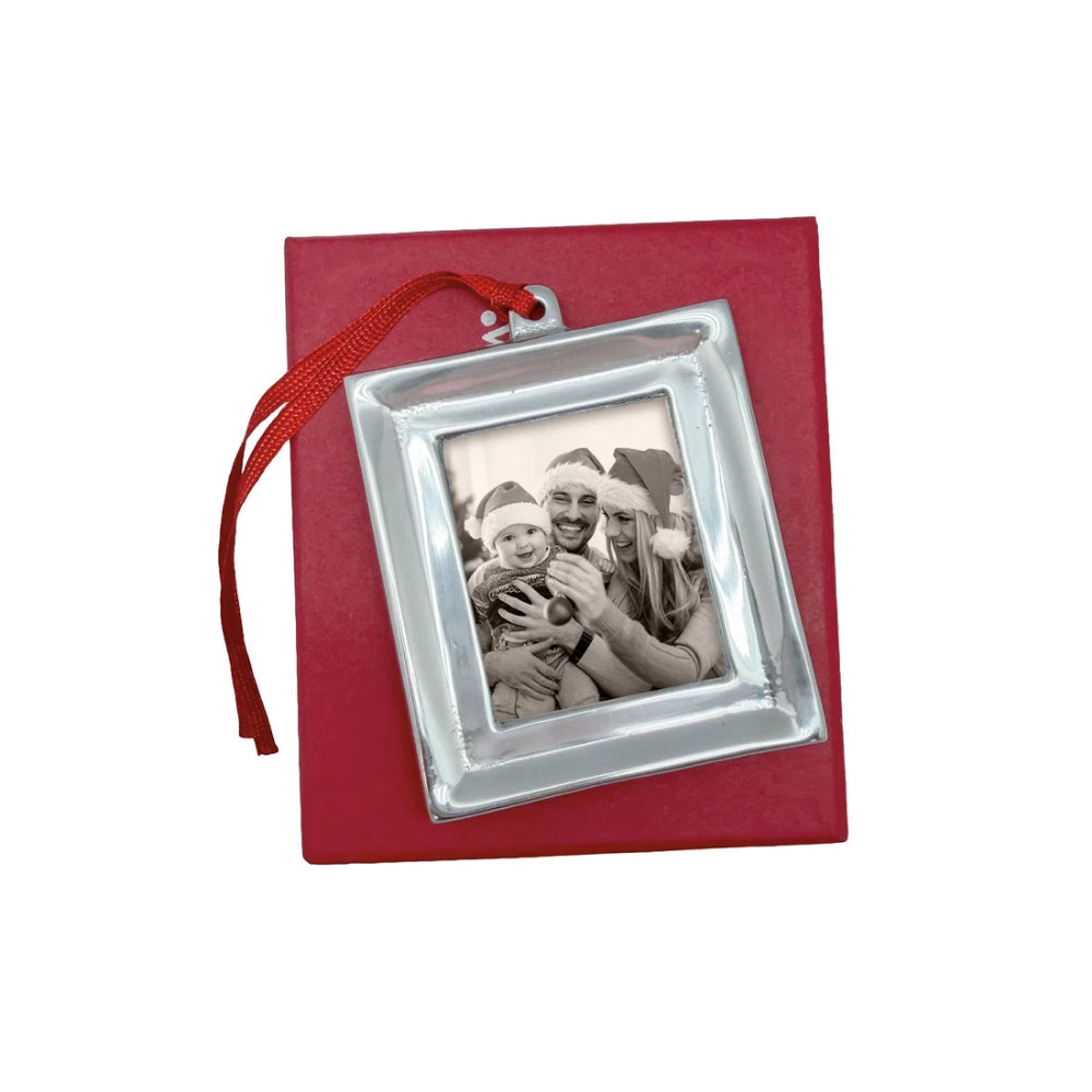 Signature photo ornament with red hanger and red box on a white backround.