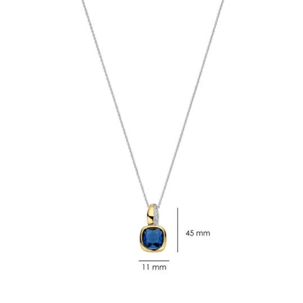 A silver chain necklace with a gold pendant featuring a cushion-cut blue gemstone and a small clear accent stone, shown on a white background with dimension labels of 11 mm and 45 mm.
