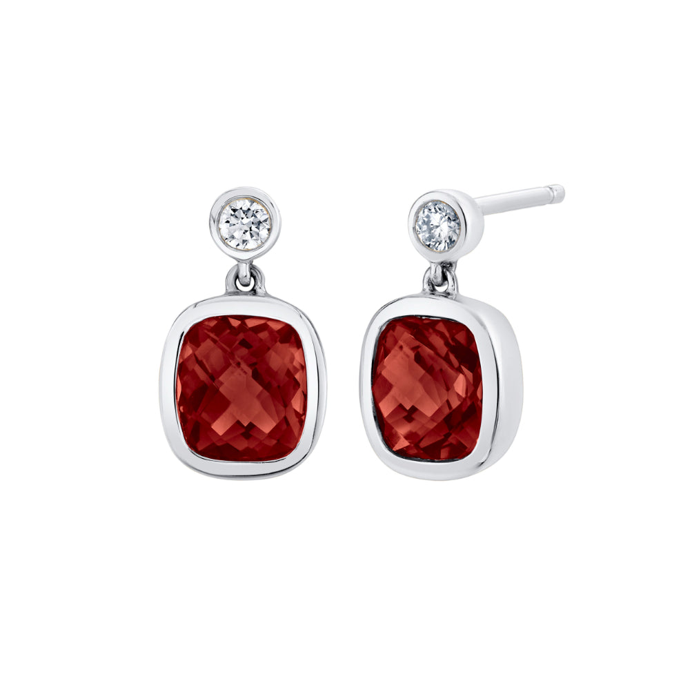 white gold earrings with garnets and diamonds on a white background