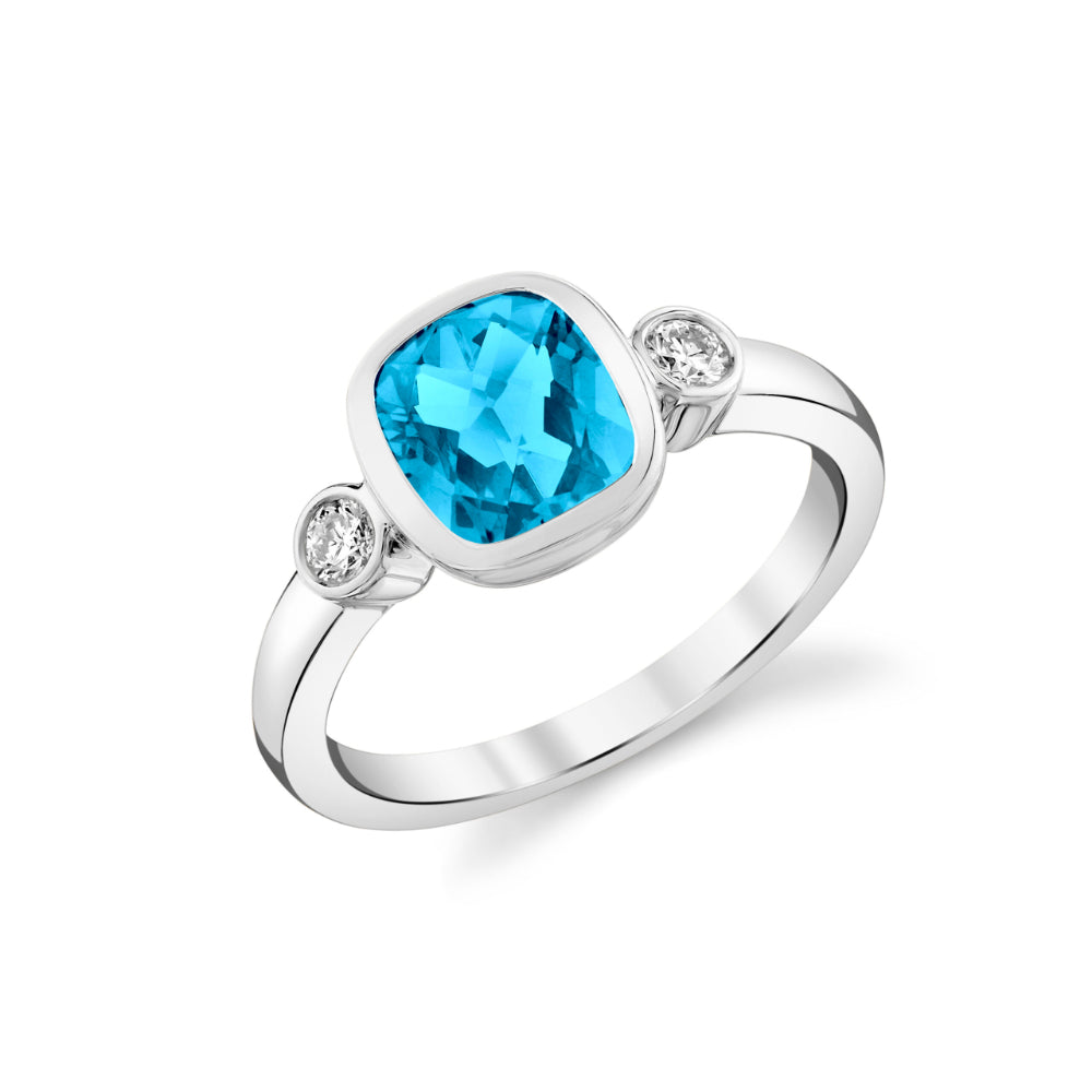 Silver ring with a blue gemstone and smaller diamonds on a white background