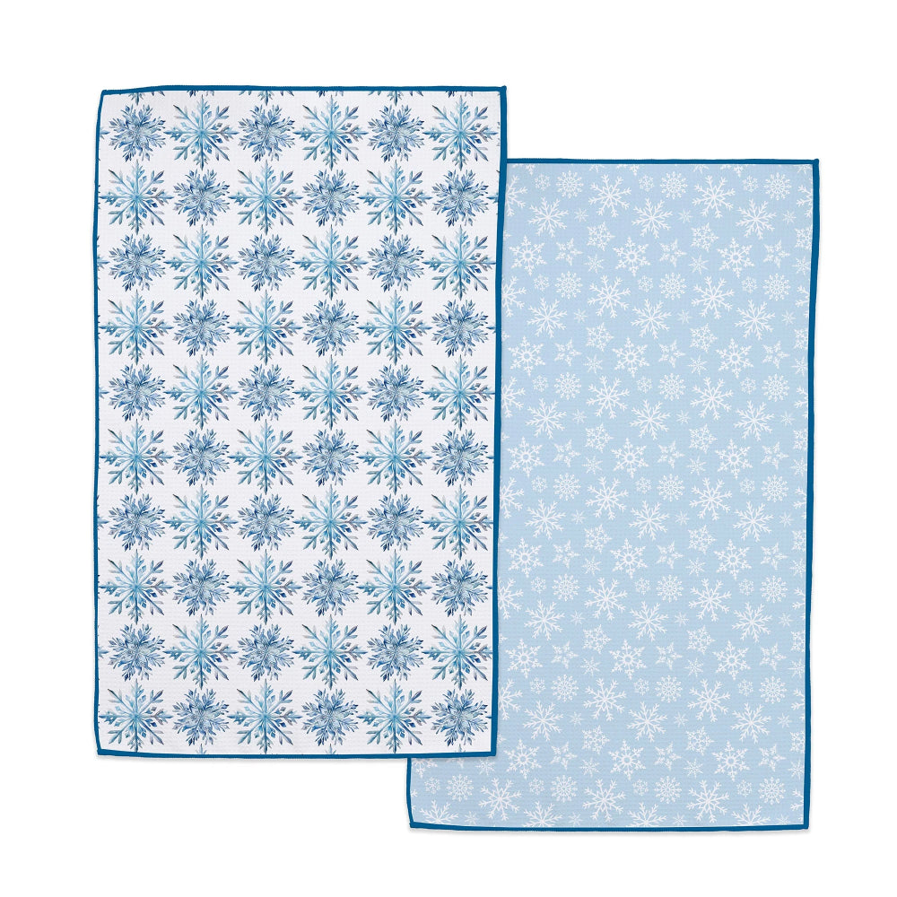 Two blue and white patterned towels on a white background