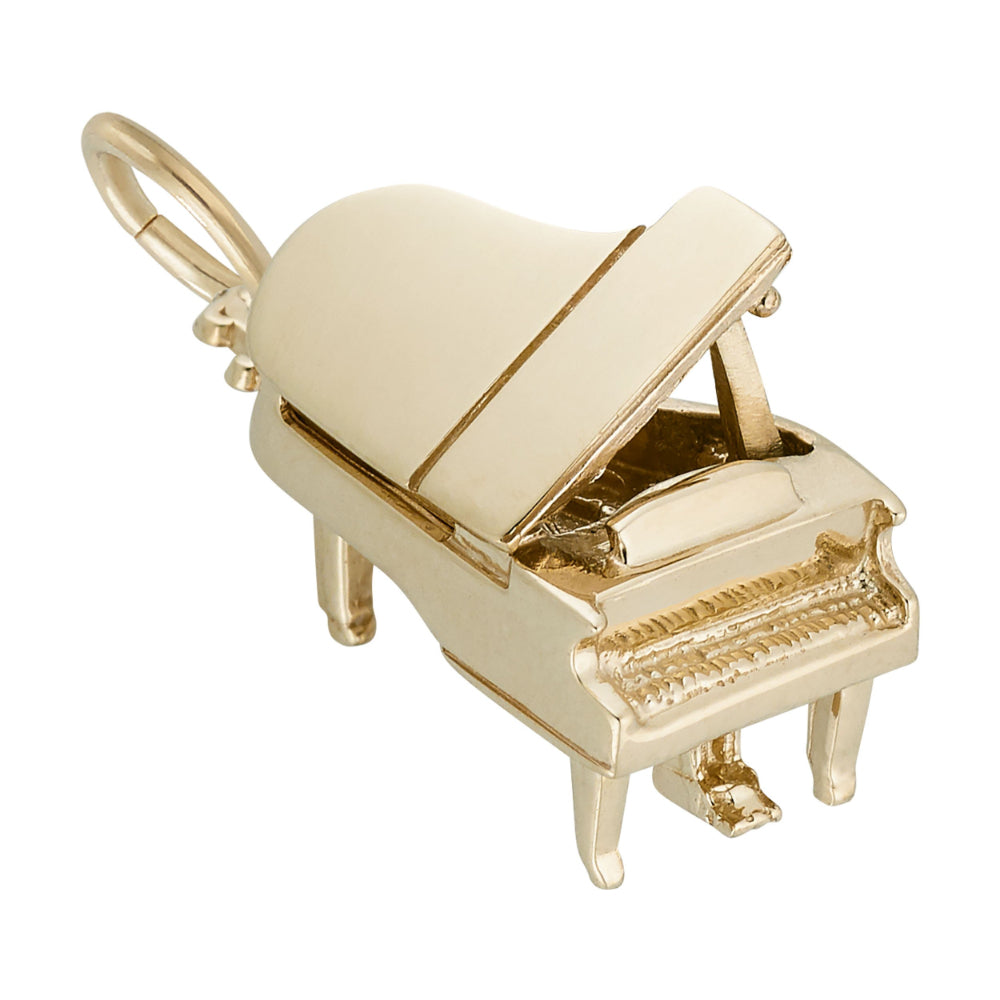 A polished gold charm shaped like a grand piano with the lid open, featuring key detailing, shown on a plain white background.
