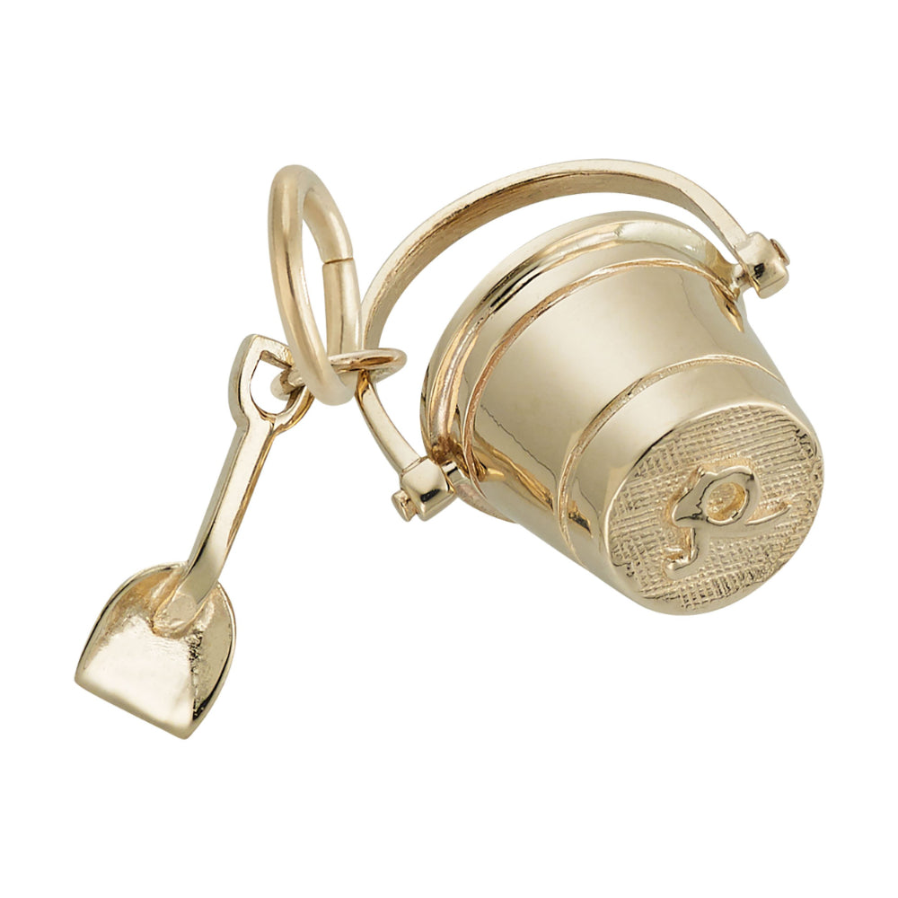 Bottom of a Gold bucket and shovel charm on a white background