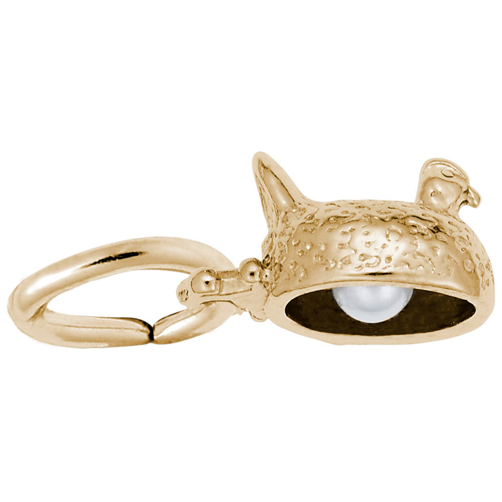 Bottom of a gold sitting chicken charm showing a pearl egg, shown on a white background