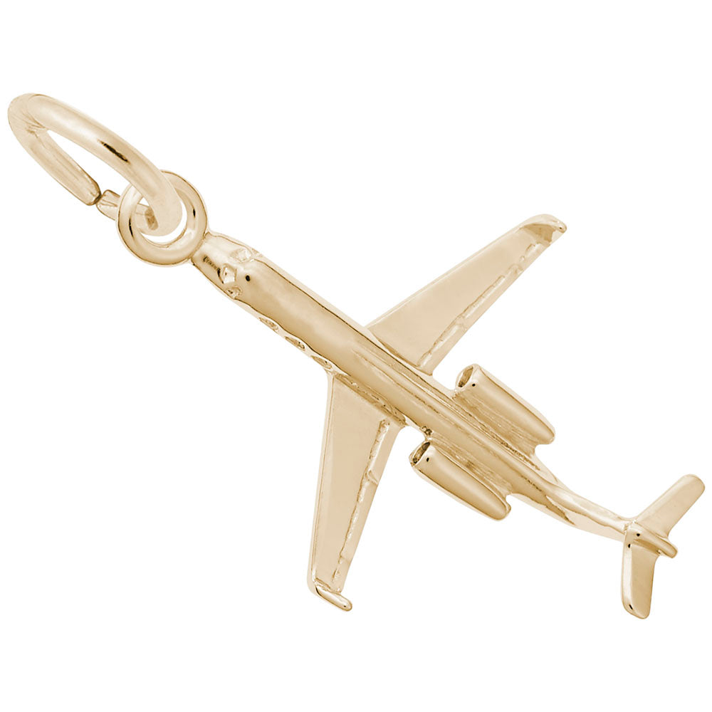 Gold airplane charm on a white background