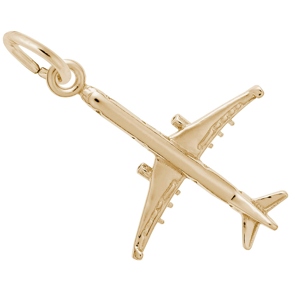 Gold airplane charm on a white background