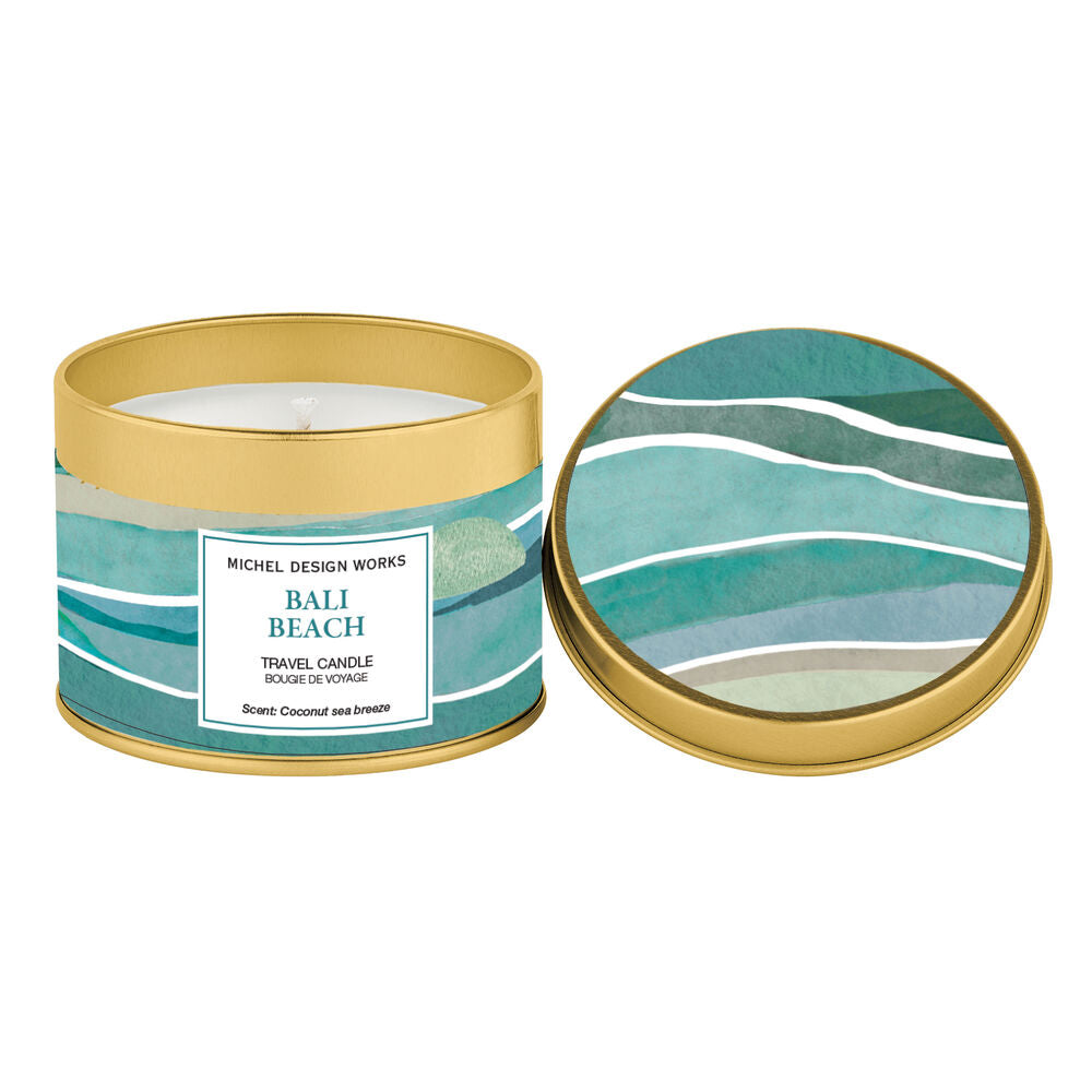 Candle in a decorative tin with a lid featuring wave patterns on a white background.