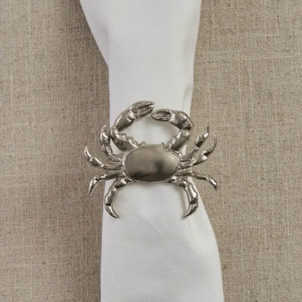 Crab Napkin Ring around white napkin on beige background surface.
