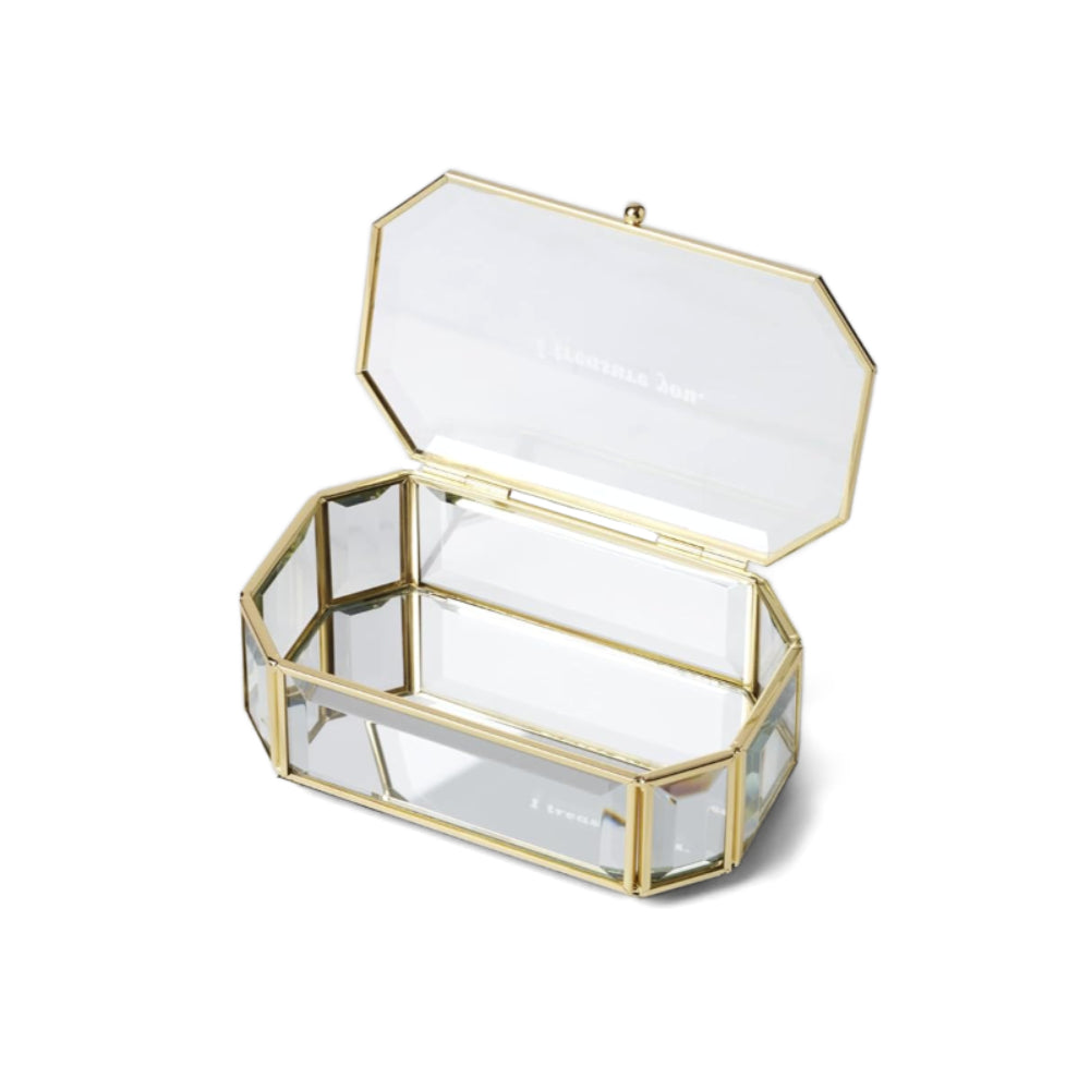 A photo of a clear rectangular hexagon shaped glass jewelry box with gold frame with the top opened on a white background