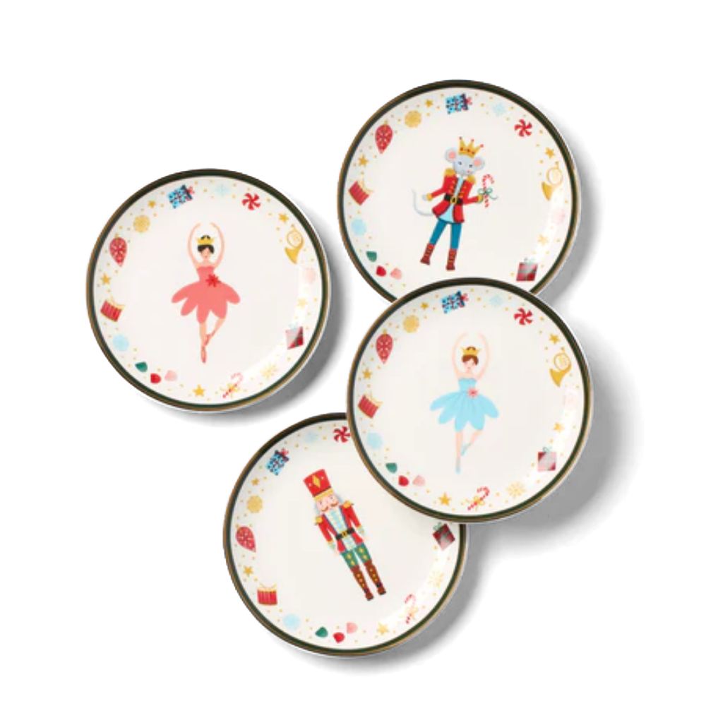 Set of four decorative plates with ballet dancer, nutcracker, and other designs on a white background.