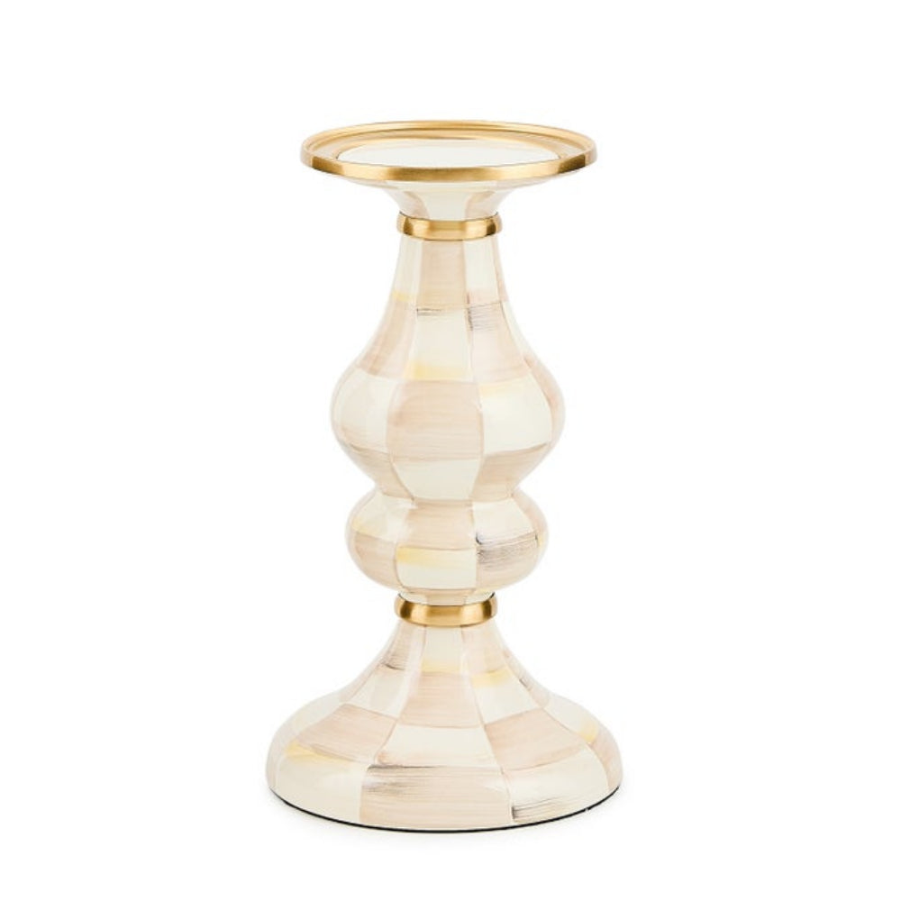 Decorative candle holder with gold accents on a white background