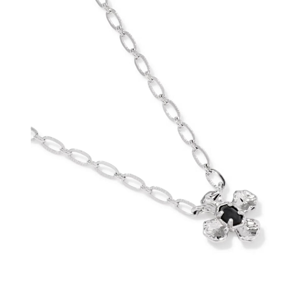 A silver chain necklace featuring a four-petal flower pendant with a central black gemstone, set against a plain white background.