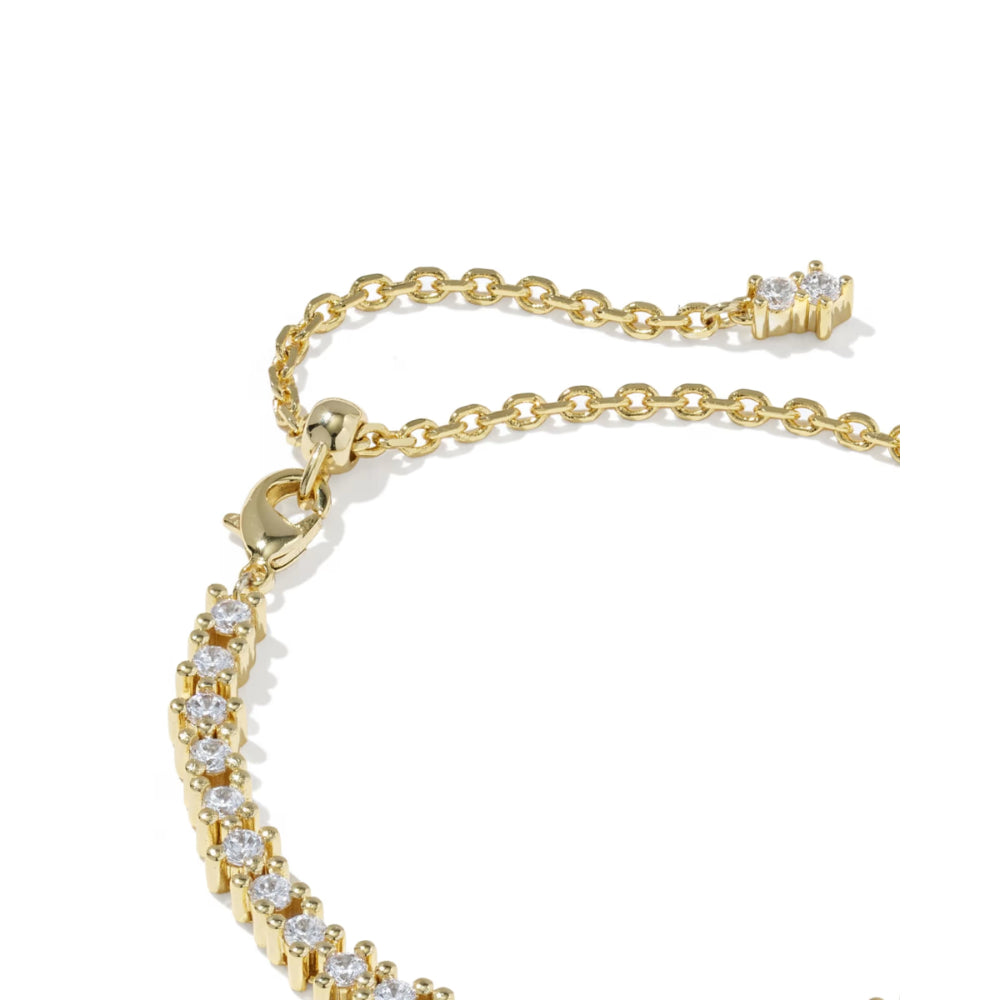 Close-up of a gold chain bracelet with a curved row of clear pavé stones and an adjustable extender chain with a small cluster of stones on a white background.