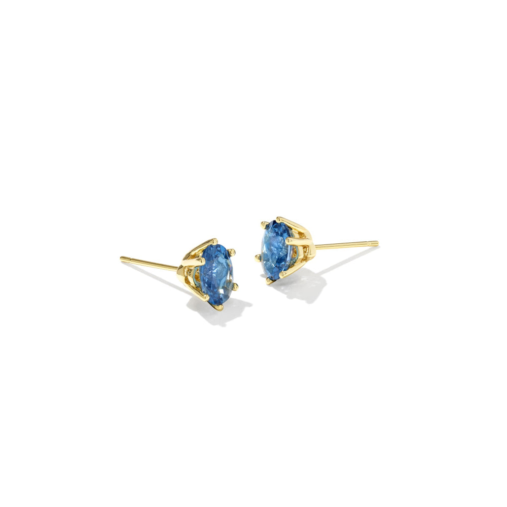 Pair of gold earrings with blue gemstones on a white background