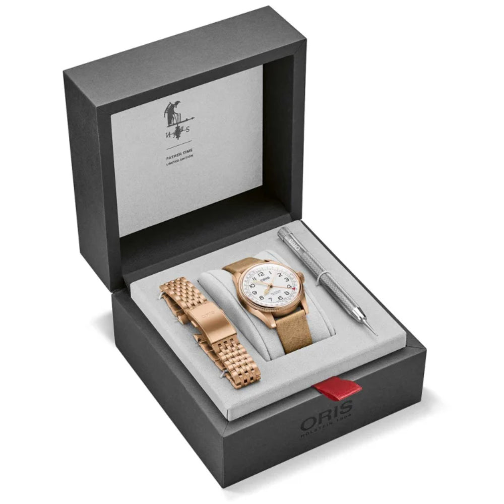 Oris watch set with rose gold watch, strap, and pen in a box