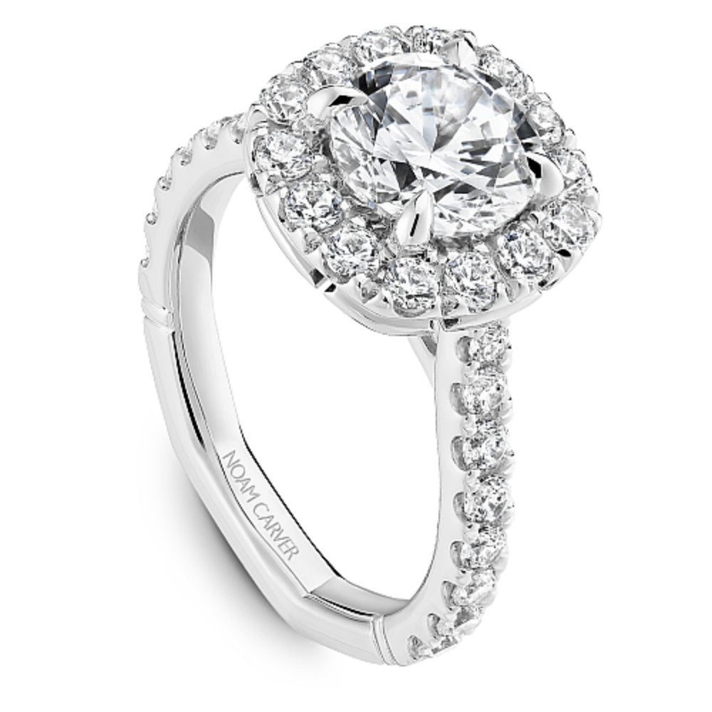 Diamond halo ring with 'Noam Carver' branding on a white background