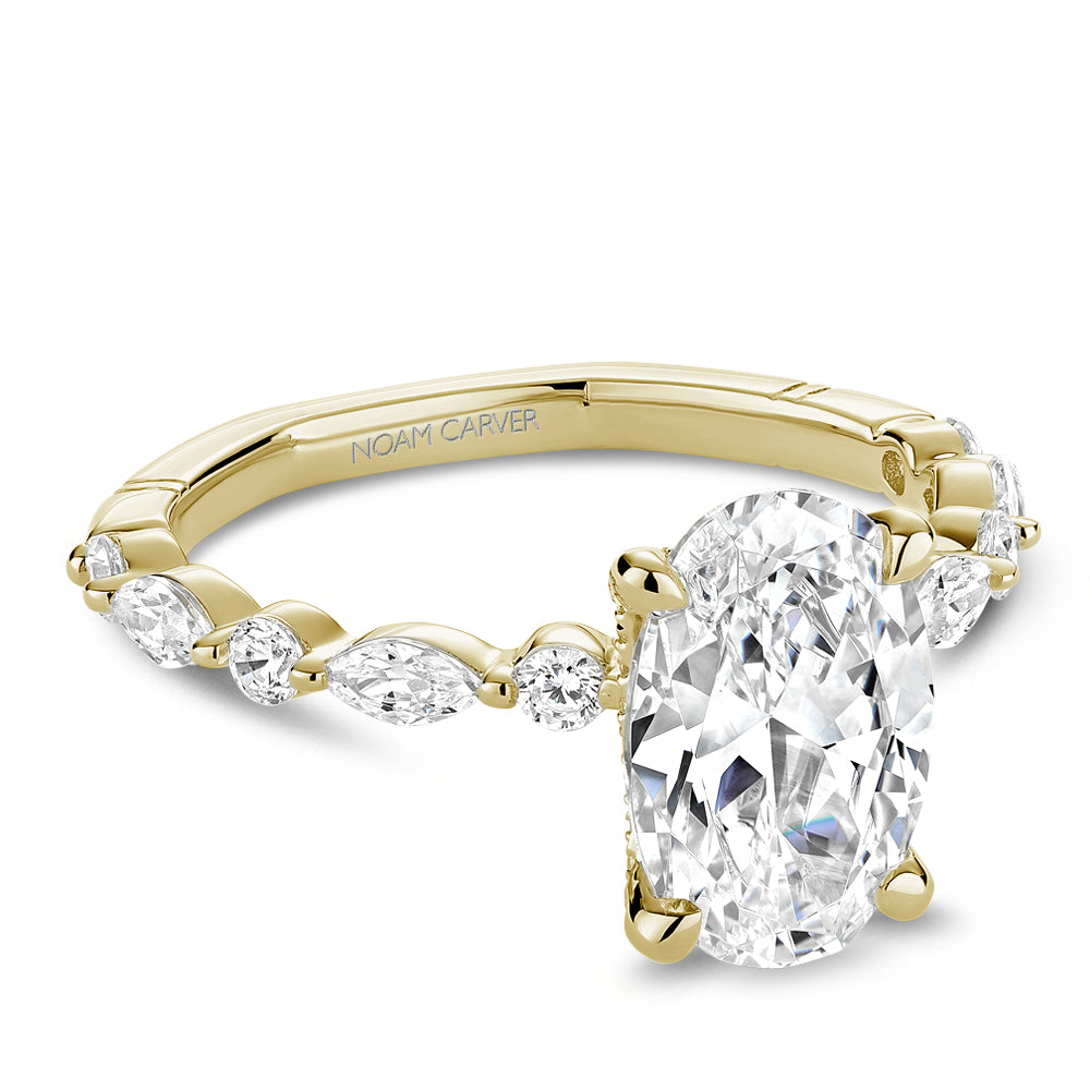 Gold diamond ring with 'Noam Carver' branding on a white background