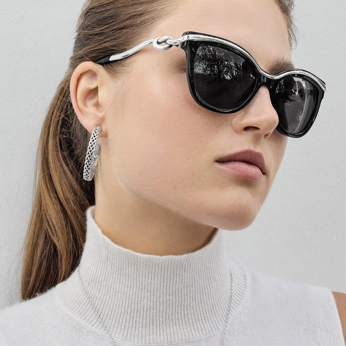 Women wearing black and silver sunglasses