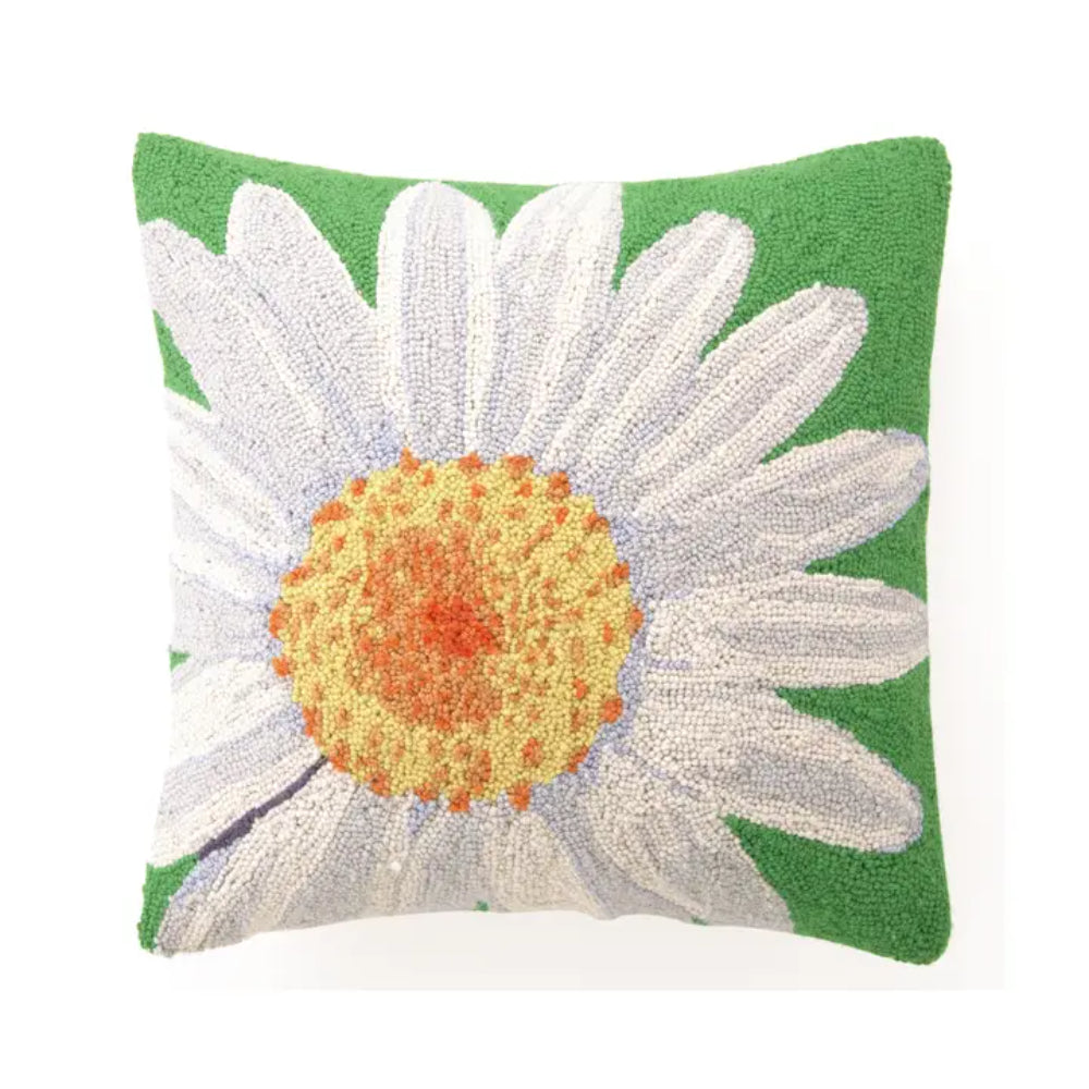 Decorative pillow with a white daisy on a green background