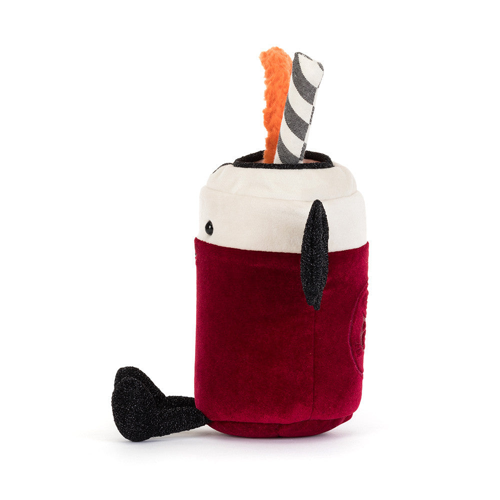 The side of a plush toy shaped like a hot chocolate cup, featuring a deep red body, a cream-colored top, a black handle, and a black-and-white striped straw with an orange loop, shown on a plain white background.