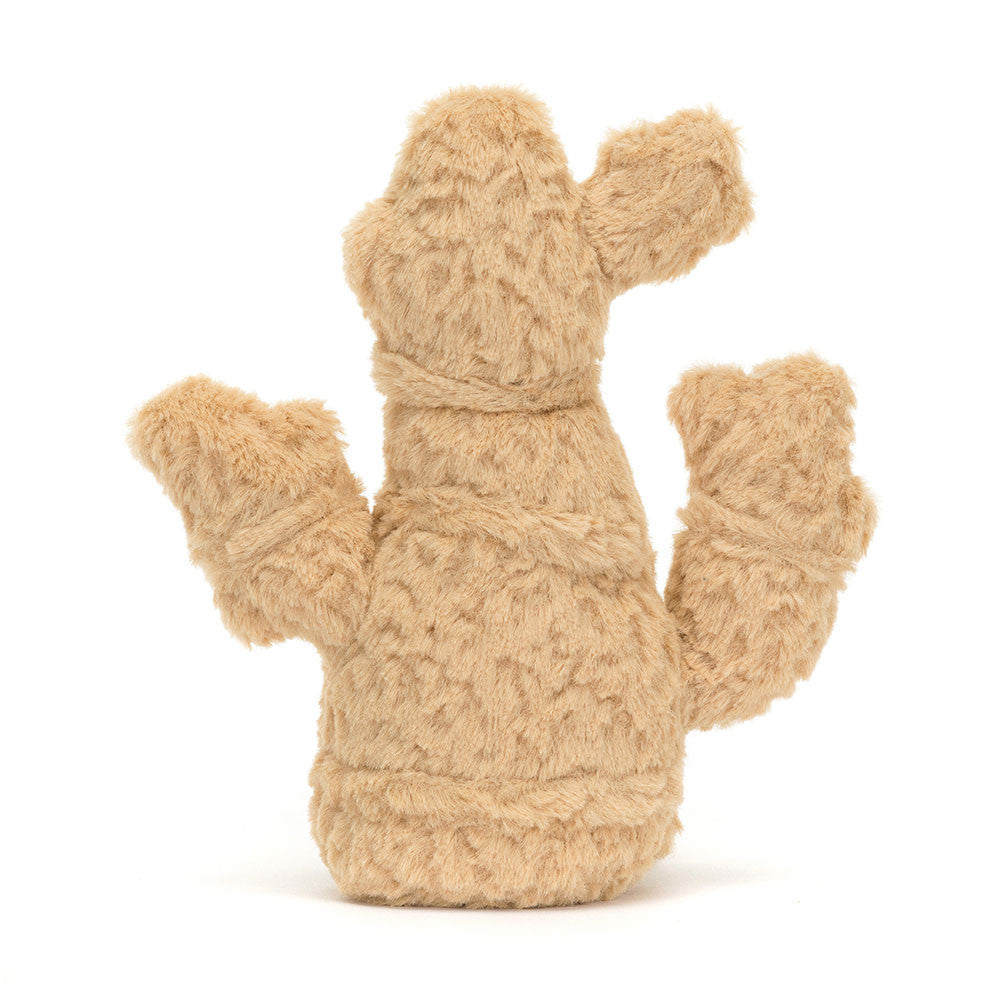 A photo of the back of a plush toy resembling a ginger root with a cheerful face, soft golden fur body, and beige corduroy-like texture. It has a pair of toffee-colored boots and is sitting upright.