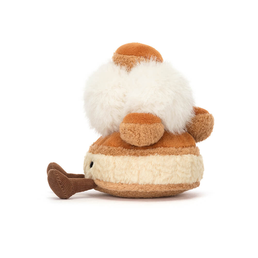 A side photo of a push toy resembling a marshmallow with brown and white colors on a white background.