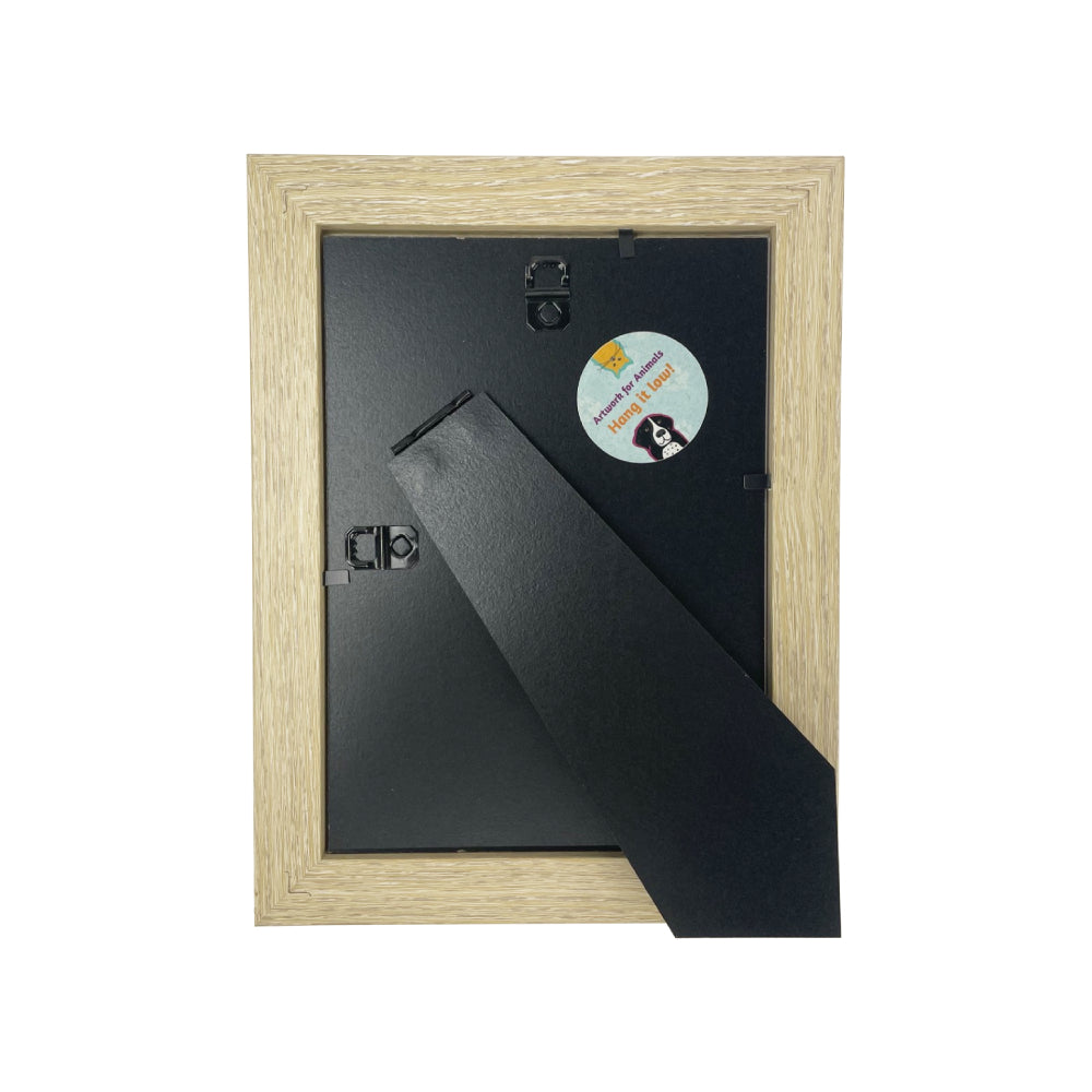 Wooden picture frame with a black mat and a round sticker on a white background.