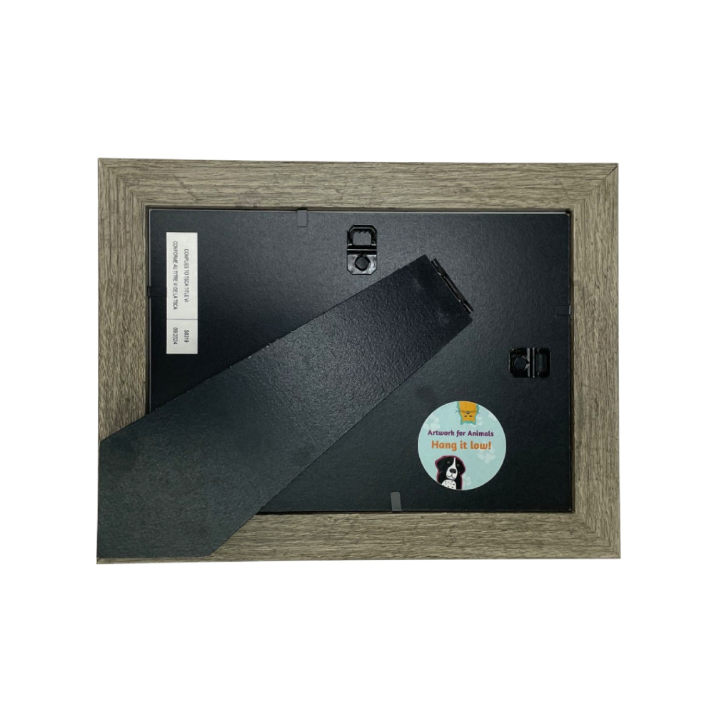 The black backing with a easel stand of an framed artwork of a green frog on a white background.
