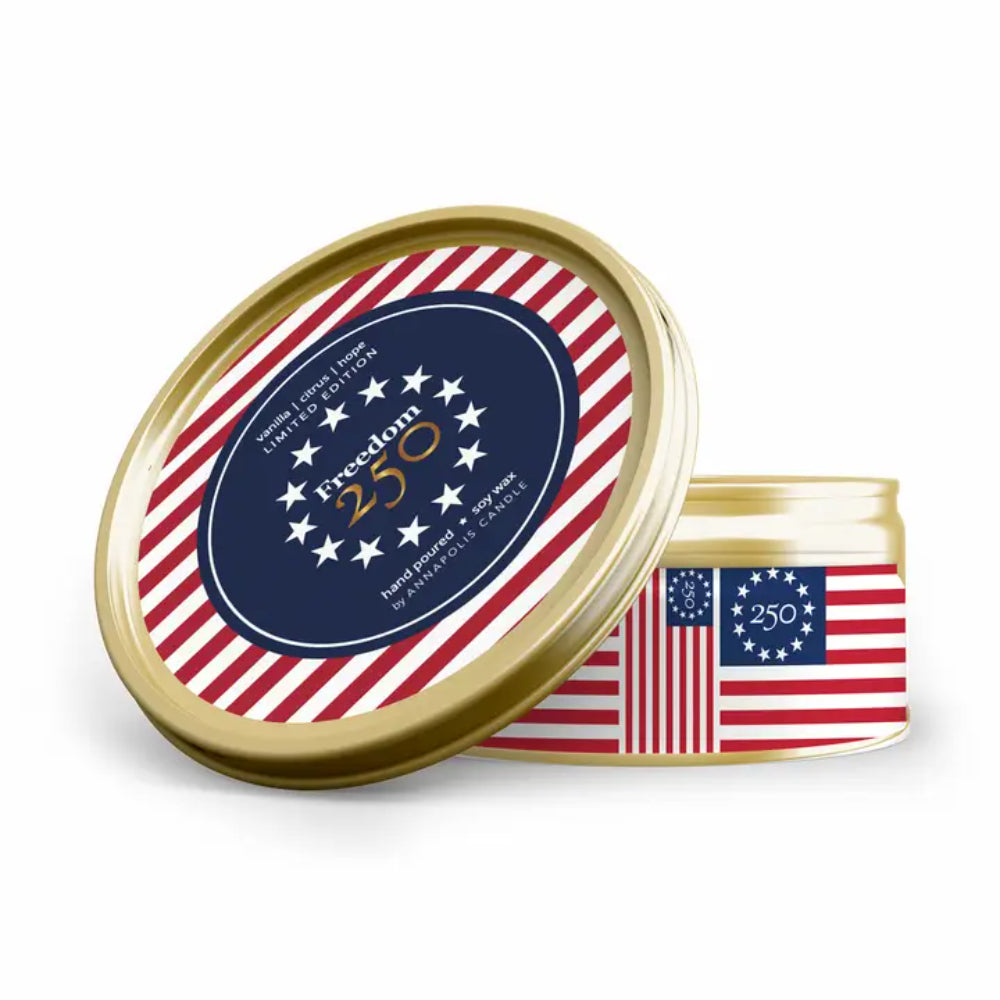 Gold tin candle with American flag design and 'Freedom 250' text on a white background.