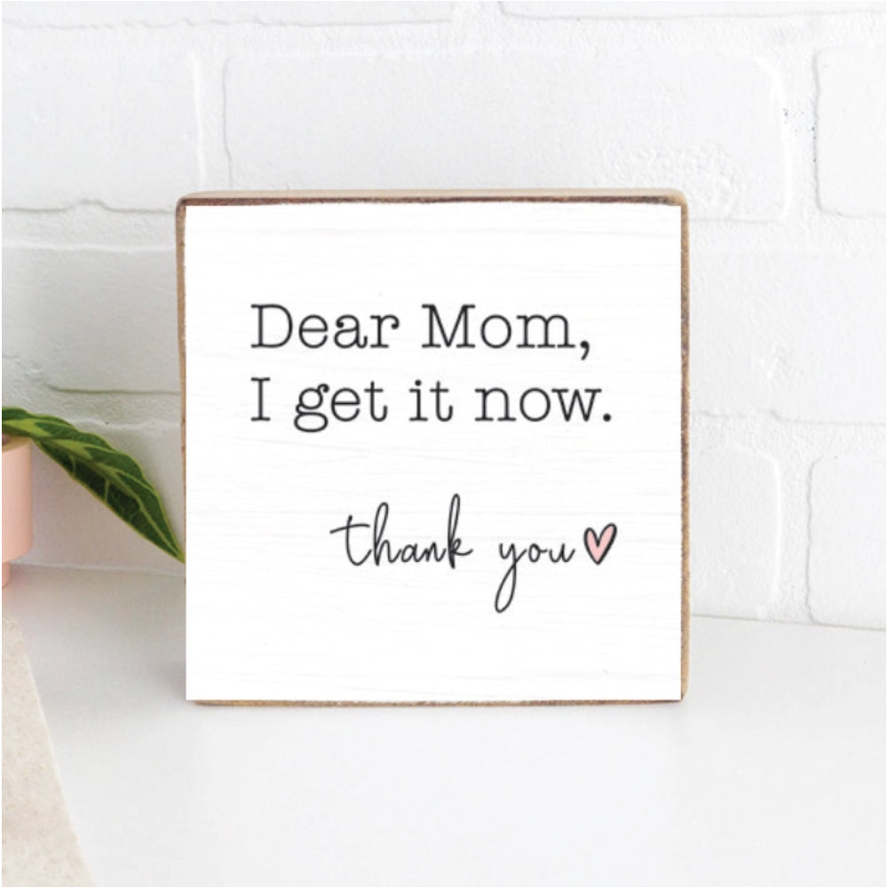 White wood decorative square block sign with text 'Dear Mom, I get it now. Thank you' on a white kitchen counter