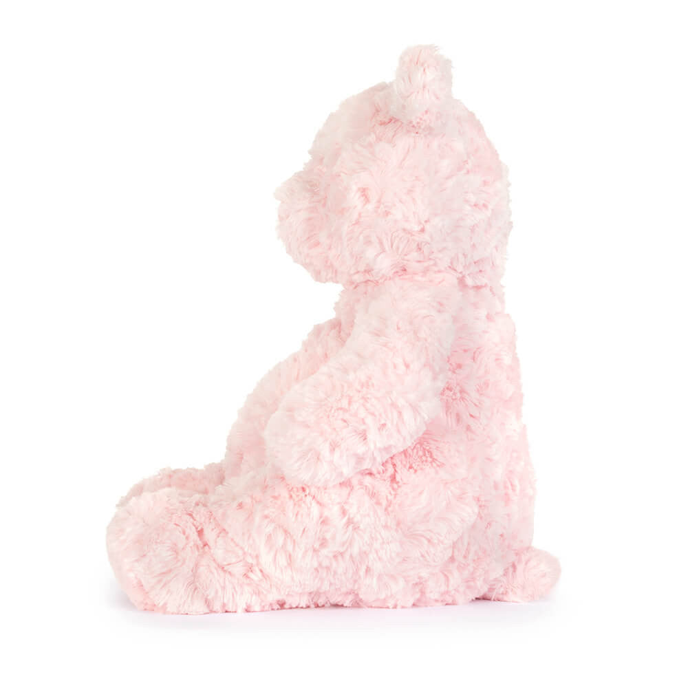 The side of a pink plush toy on a white background.