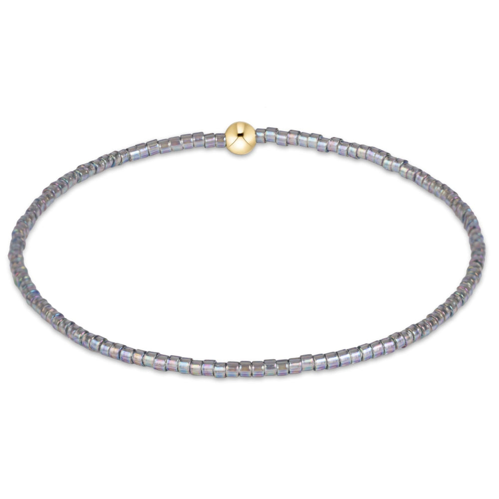 A delicate beaded bracelet with small, faceted gray beads displayed on a clean white background.