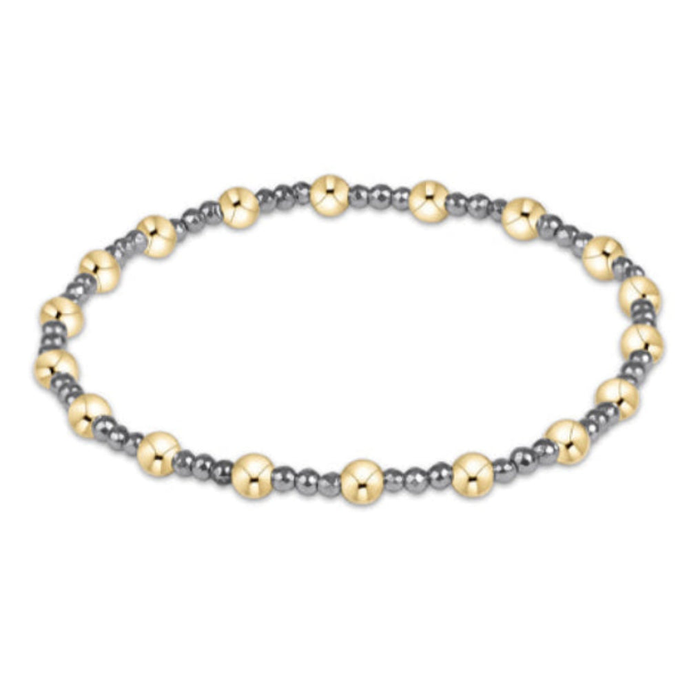 A beaded stretch bracelet featuring alternating polished gold-tone and matte silver-tone beads, arranged in a circular shape against a plain white background.