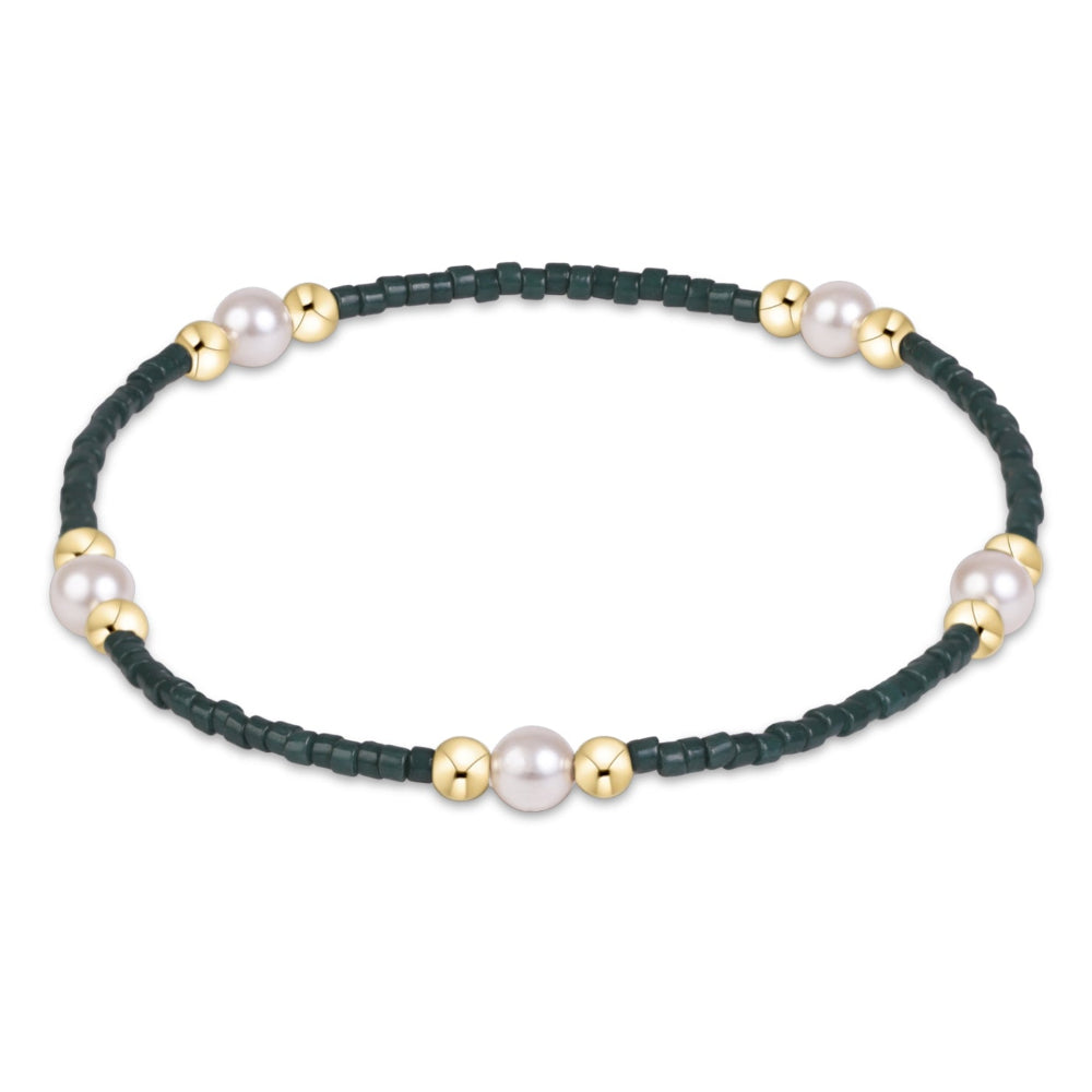 A delicate braided bracelet in dark green cord, accented with five white freshwater pearls and small gold spacer beads, shown on a plain white background.