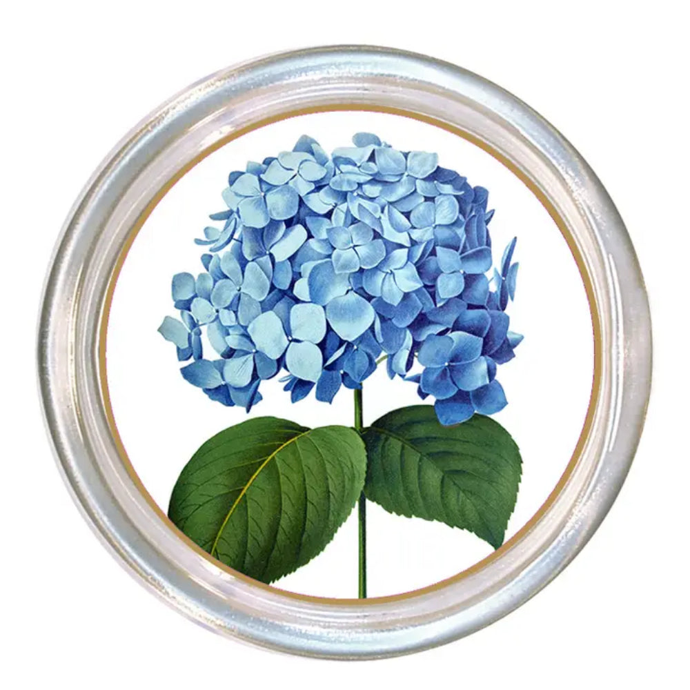 Round coaster with blue hydrangea flowers and green leaves on a white background
