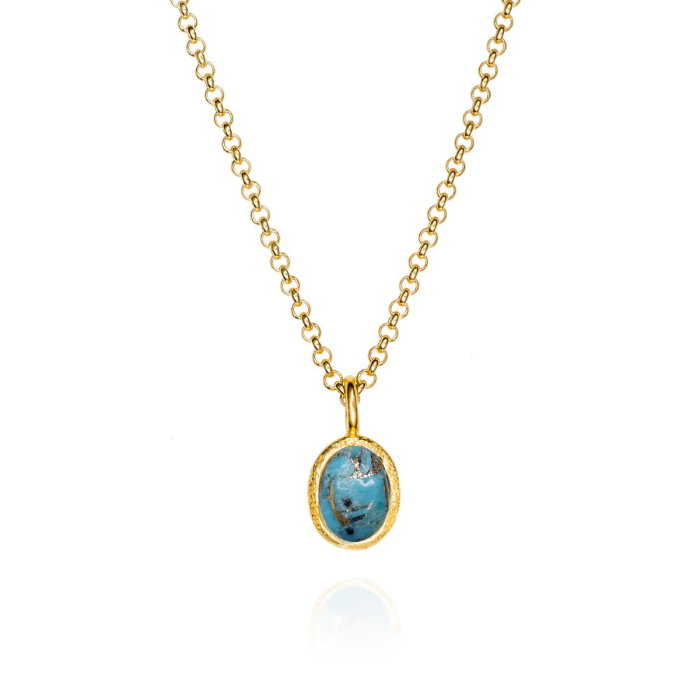 Gold necklace with a blue pendant on a white background