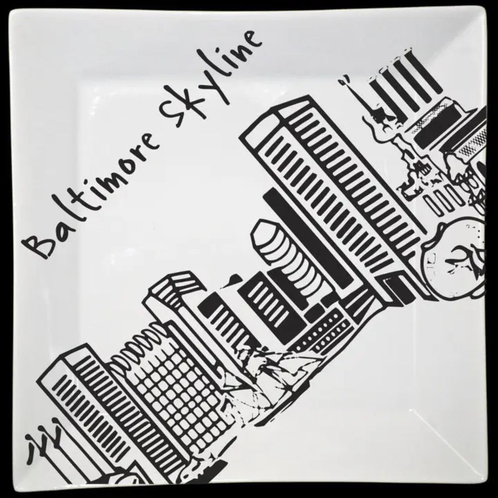 Square plate with black and white illustration of Baltimore skyline on a white background