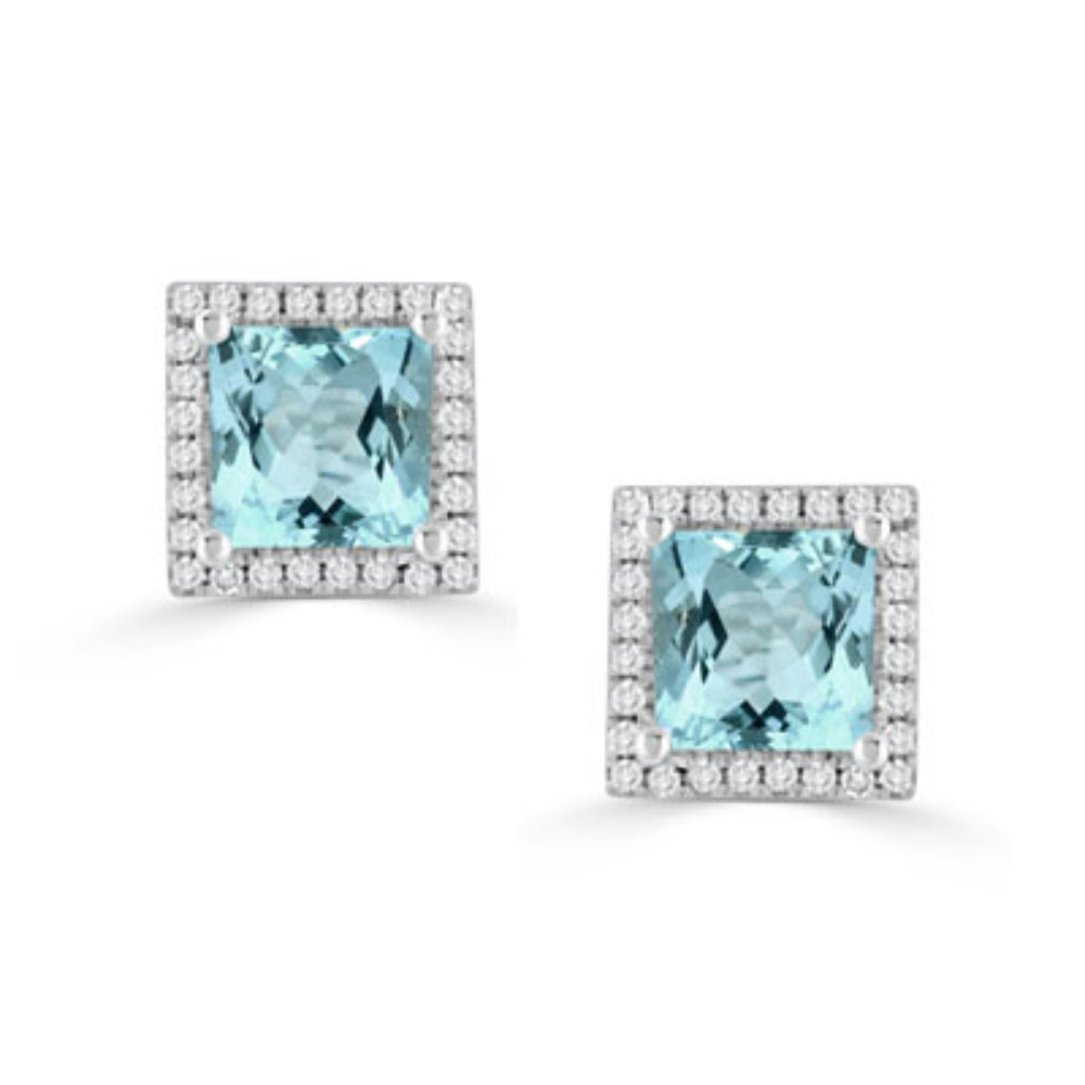 silver tone earrings with blue stones and clear stones around on a white background