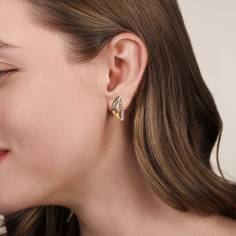 Woman wearing silver and gold earring