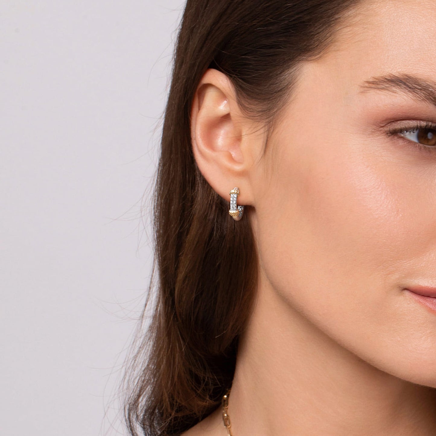 Close-up of a woman wearing white sapphire earrings