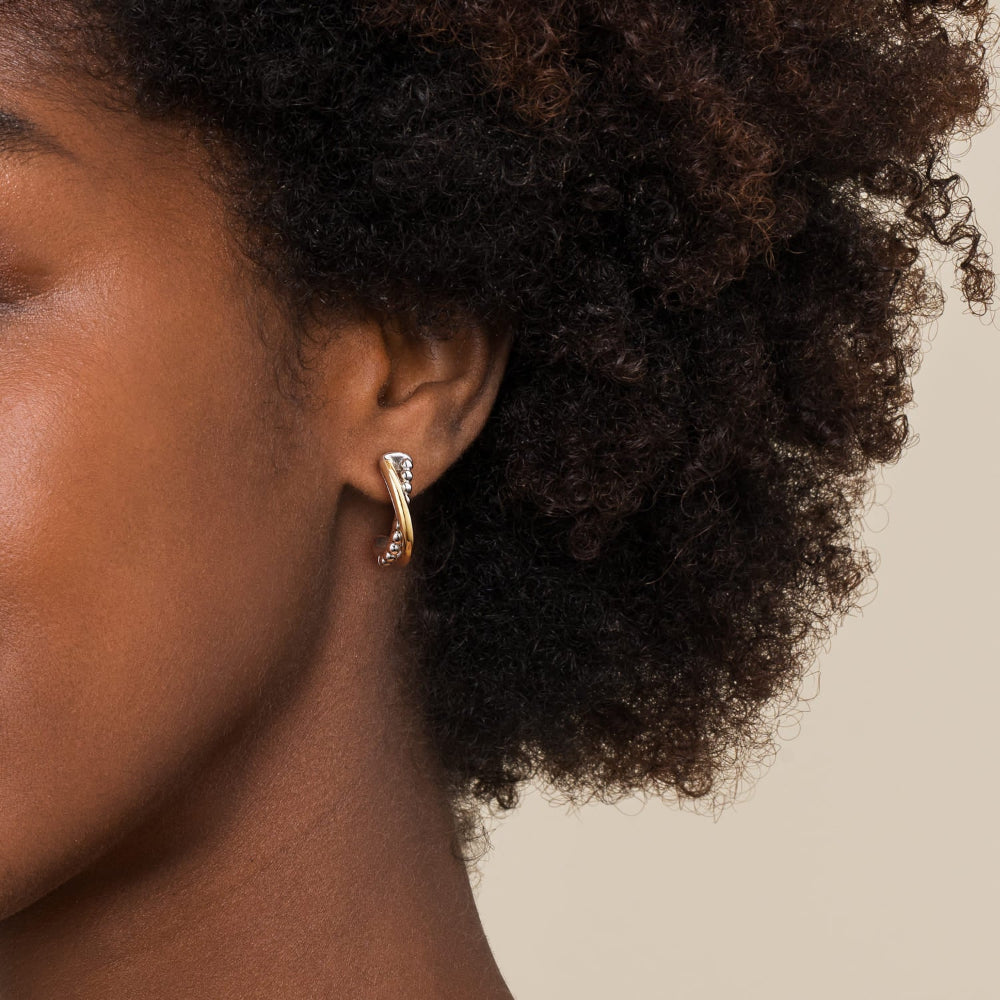 Close-up of a person wearing a gold earring