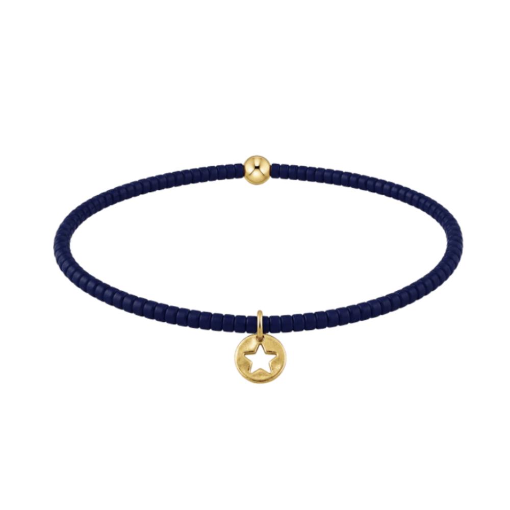 Navy blue bracelet with gold star disc on a white background