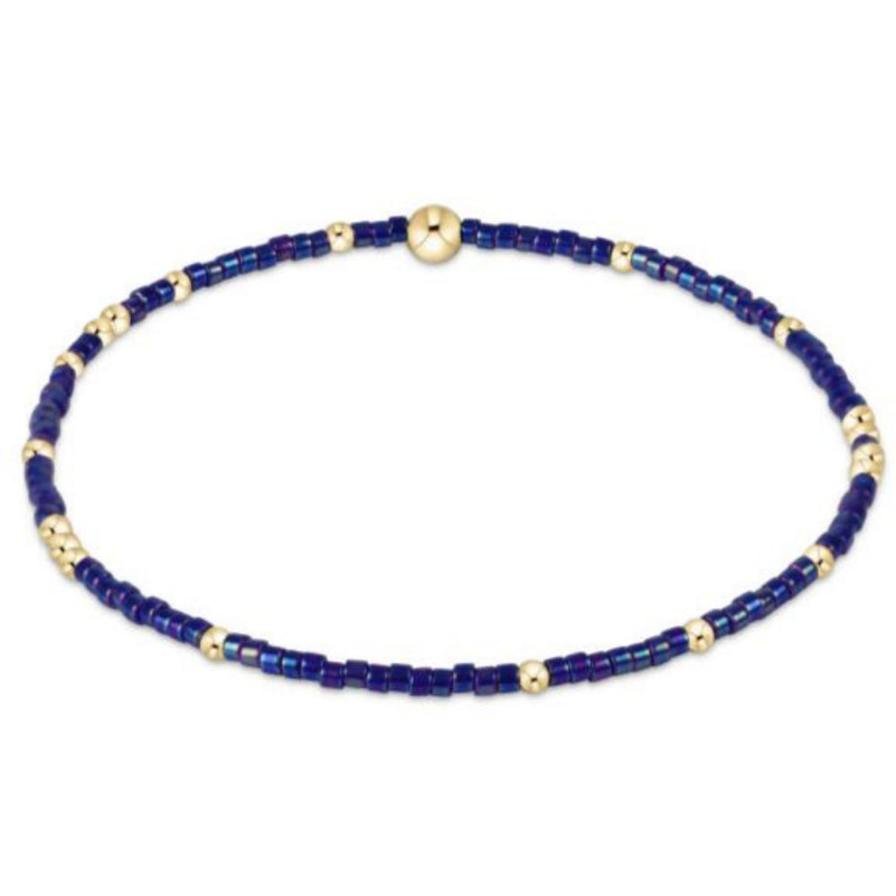Bracelet with dark blue beads and gold accents on a white background