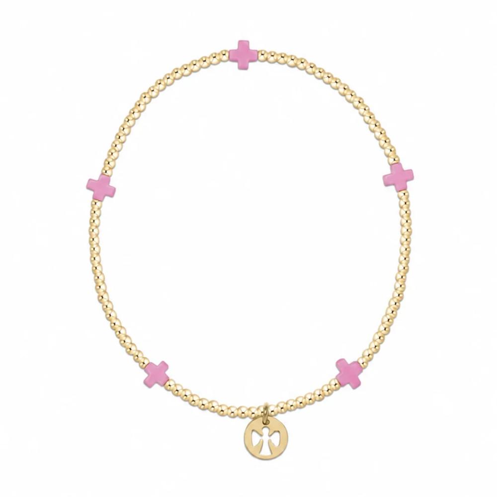 A gold chain bracelet with five pink enamel crosses spaced evenly along the chain and a small gold pendant at the bottom, shown on a plain white background.